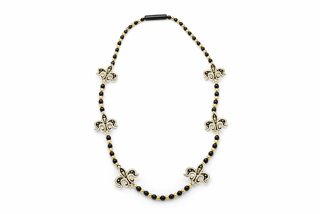 Necklace with black beads and gold fleur-de-lis pendants on a white background